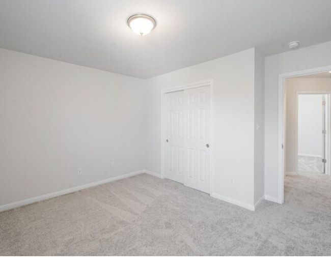 Unfurnished bedroom featuring carpet floors and a closet | Image 15