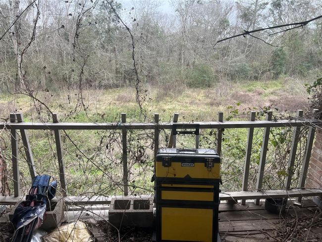 This is a view toward the Chocolate Bayou from the upper balcony off the living room. It can be a beautiful property when it's cleaned up. | Image 31