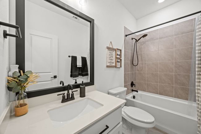 Full bath featuring toilet, vanity, and shower / bath combo | Image 12