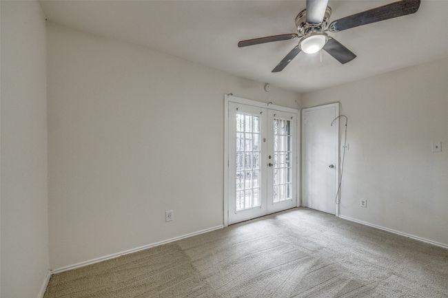 Spare room featuring carpet, a ceiling fan, and french doors | Image 15