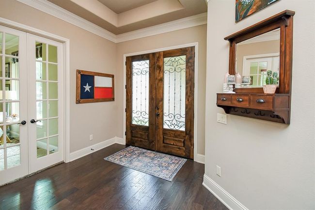 Breathtaking entry with wood floors, tray ceiling, crown molding and 6" baseboards. | Image 8