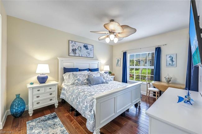 Bedroom featuring dark wood-type flooring and ceiling fan | Image 11