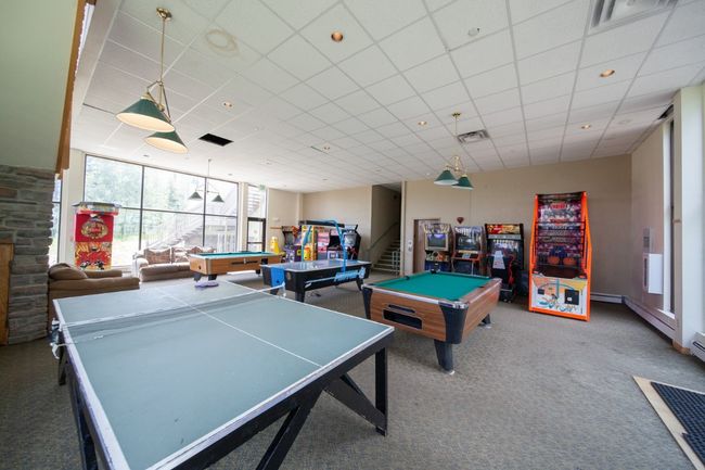 Recreation room with billiards table, carpet floors, and a paneled ceiling | Image 21