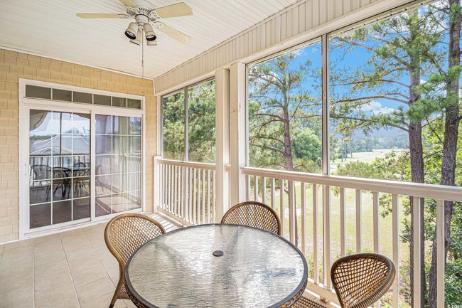 Sunroom featuring a ceiling fan, outdoor dining space, and healthy amount of natural light | Image 25