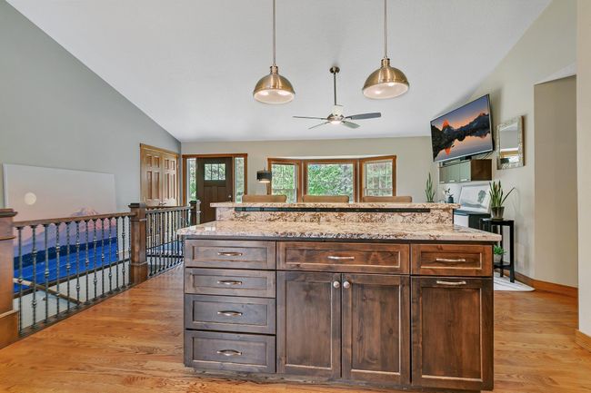 Raised center island with breakfast bar overlooking the living room | Image 4