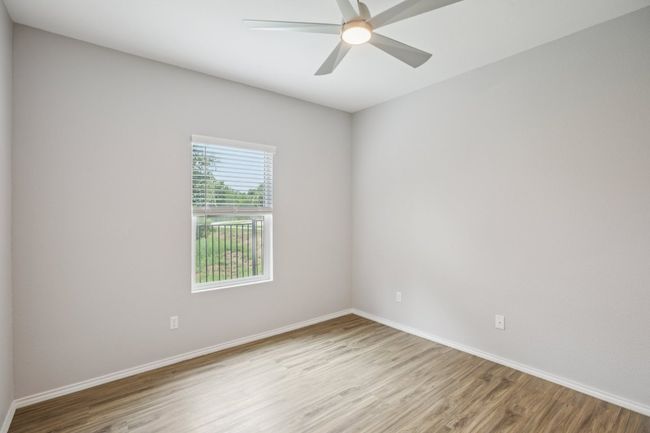 Office/4th bedroom with vinyl plank flooring, overlooks the greenbelt on the side of the home. | Image 17