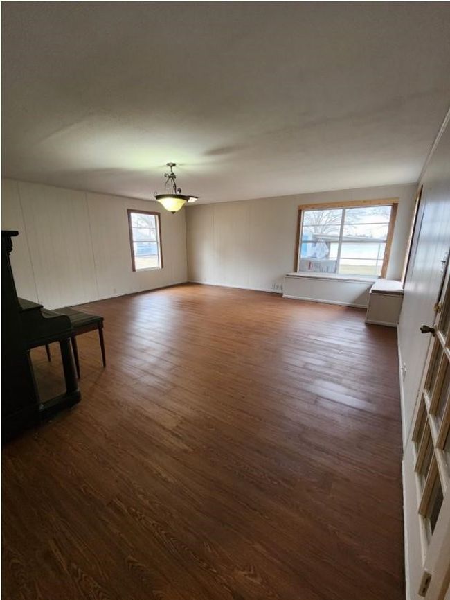 Unfurnished living room featuring dark wood-type flooring | Image 19