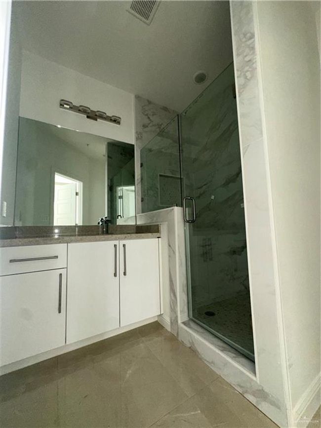 Full bathroom featuring vanity, visible vents, and a marble finish shower | Image 6