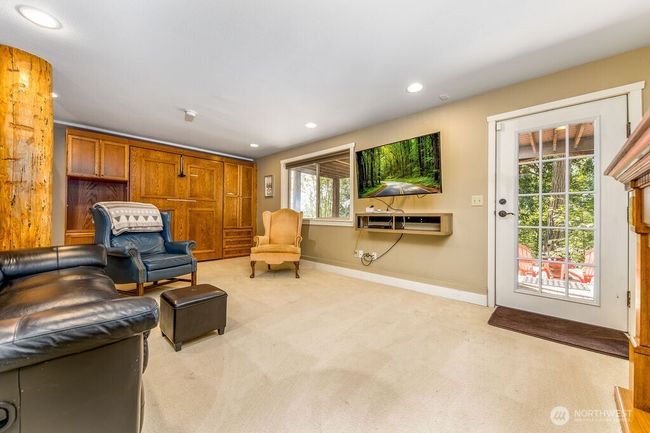 Family/rec room walks out to fire pit area and garden. Also has additional murphy bed for guests! | Image 17