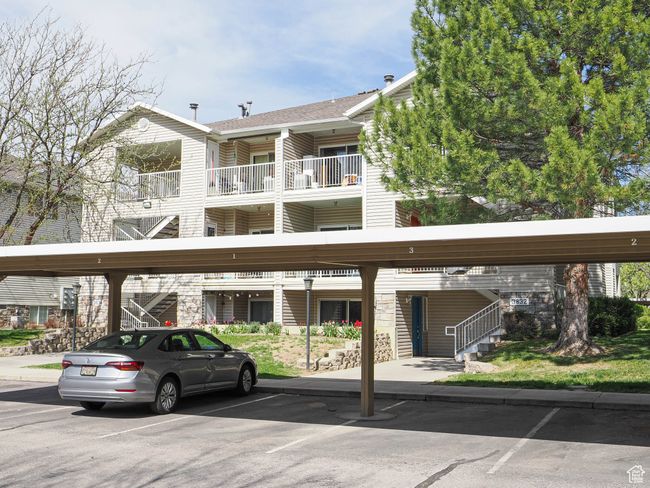 View of building exterior with covered parking | Image 22