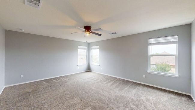 Unfurnished room with visible vents, carpet flooring, plenty of natural light, and ceiling fan | Image 24