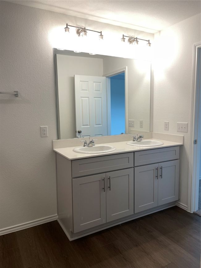 Full bath featuring double vanity, wood finished floors, and baseboards | Image 14