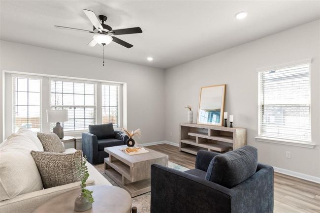 Living room with baseboards, light wood-style floors, ceiling fan, and recessed lighting | Image 6