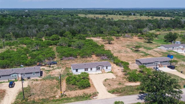 Aerial view of property and surrounding area with a heavily wooded area | Image 38