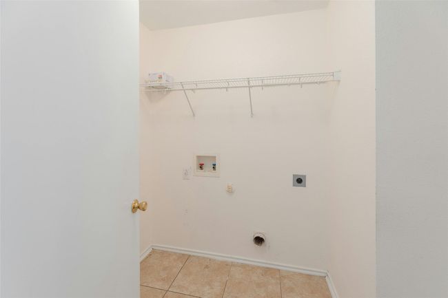 Washroom featuring light tile patterned flooring, washer hookup, electric dryer hookup, laundry area, and gas dryer hookup | Image 12