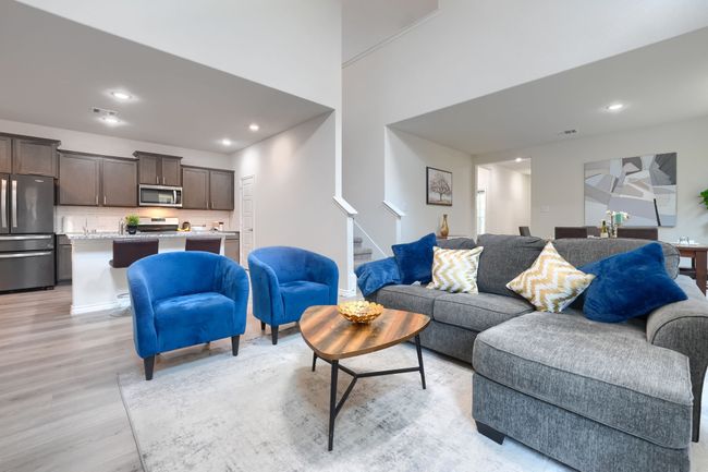 Living room featuring stairs, light wood finished floors, and recessed lighting | Image 9
