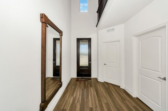 Entryway featuring a towering ceiling, baseboards and dark wood-style flooring | Image 6