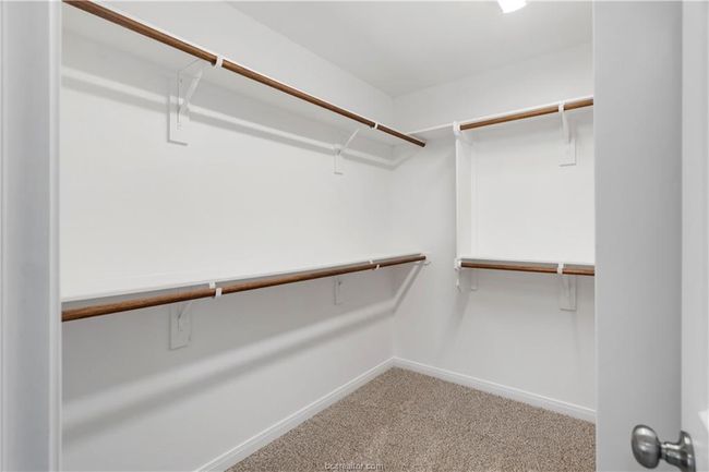 Spacious closet with carpet flooring | Image 14