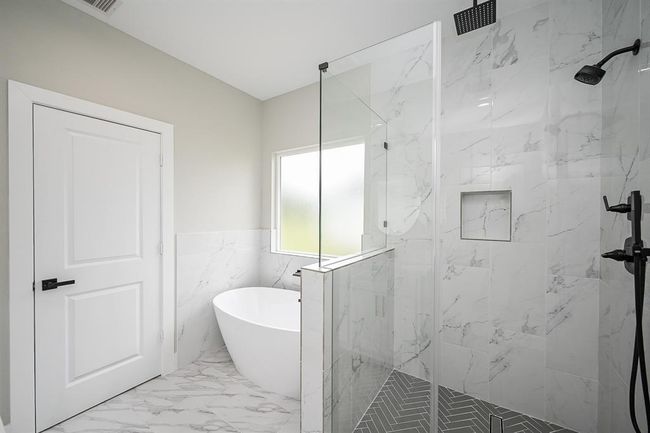 Unwind & Relaxed In This Fancy Bathtub For A Nice Experience Or You Have The Option Of Using The Glass Stand Up Shower That Is Gorgeous With The Tiled Backsplash & Modern Shower Fixtures | Image 26