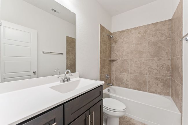Bathroom featuring visible vents, toilet, vanity, and washtub / shower combination | Image 15