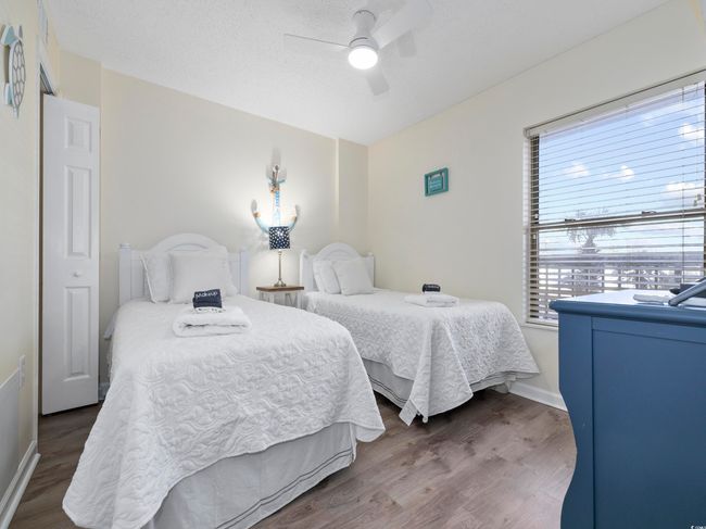 Bedroom featuring ceiling fan, wood finished floors, baseboards, and a textured ceiling | Image 18
