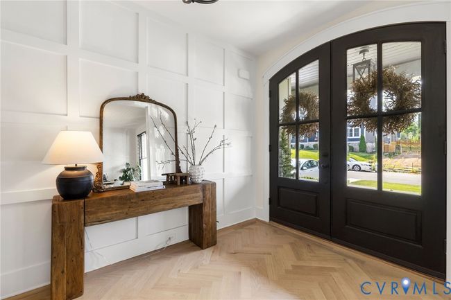 Entryway with a decorative wall, french doors, and arched walkways | Image 10