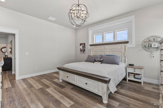 Bedroom featuring a chandelier and dark wood-style flooring | Image 24