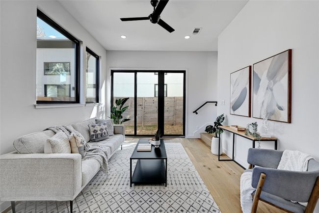 Living room featuring ceiling fan and light hardwood / wood-style flooring | Image 5