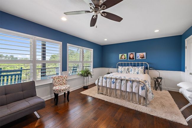 Bedroom featuring wood-type flooring, a ceiling fan, recessed lighting, and wainscoting | Image 34
