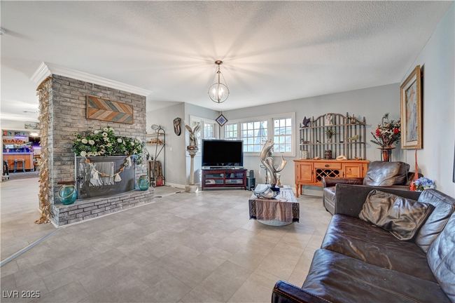 Living room featuring a brick fireplace and a textured ceiling | Image 31