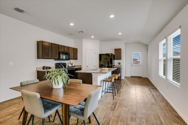 Dining area with visible vents, lofted ceiling, baseboards, recessed lighting, and light wood-style flooring | Image 6