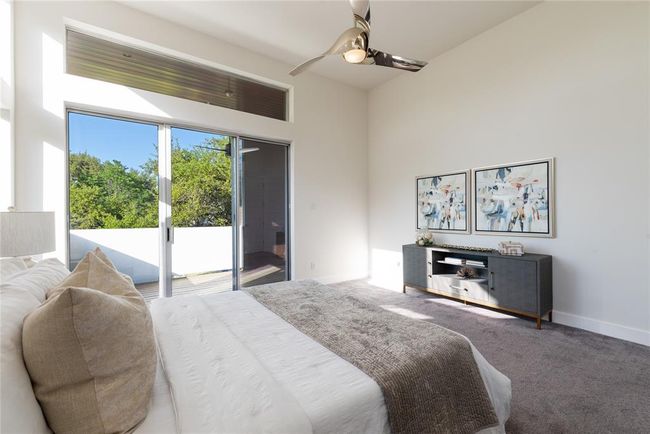 Carpeted bedroom featuring access to exterior, a ceiling fan, and baseboards | Image 19
