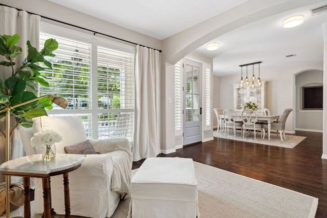 Picture windows with custom plantation shutters overlook the front yard. | Image 15