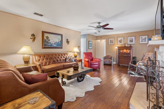 DEN with ceiling fan, dark hardwood / wood-style flooring, and a high end fireplace | Image 11