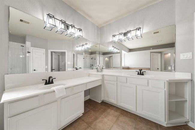Included is plenty of cabinet and drawer storage along with a make-up vanity. | Image 25