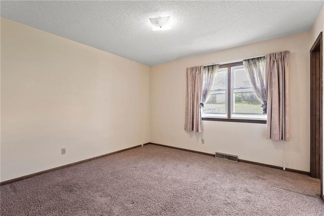 Carpeted spare room with a textured ceiling and baseboards | Image 19