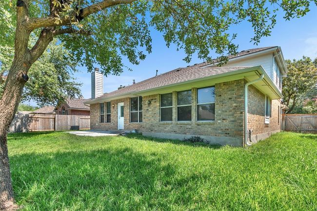 Back of property featuring a patio area, a chimney, and brick siding | Image 28