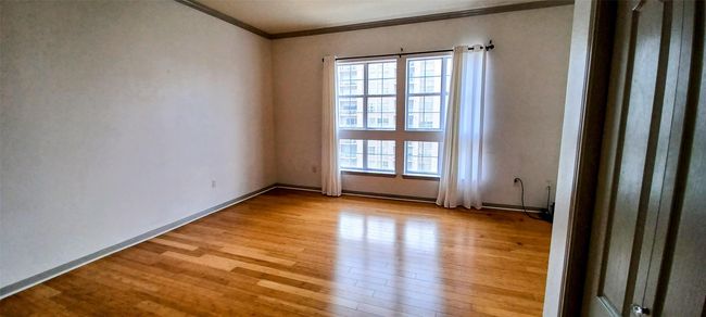Great Living Space with Attractive Wood Floors and Moldings. Track Lighting in Corner Could Perfect for Office Desk or Dining Space | Image 26
