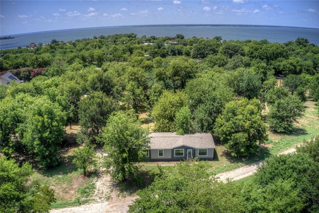 View of subject property with a nearby body of water and a heavily wooded area | Image 29