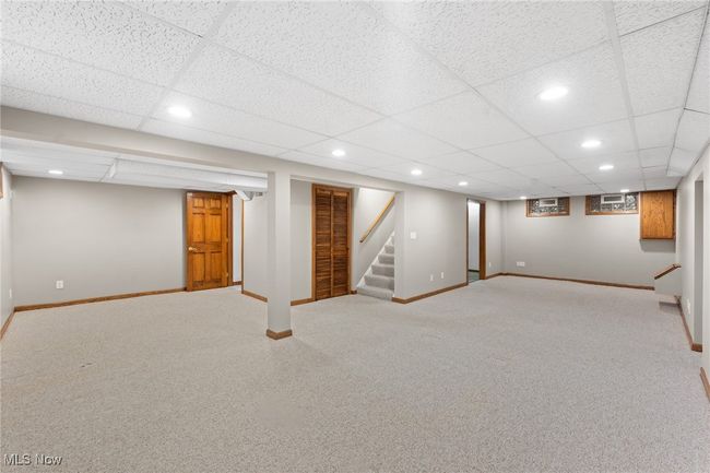 Basement featuring a drop ceiling and carpet | Image 23