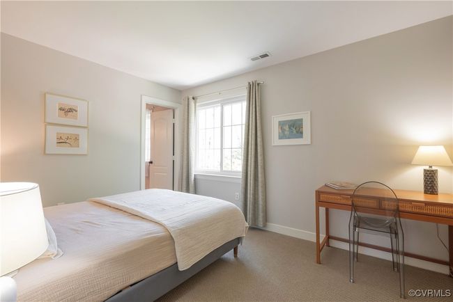 Bedroom with light carpet, visible vents, and baseboards | Image 28