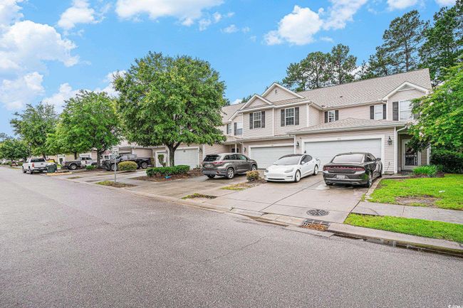 View of property featuring concrete driveway and a garage | Image 23