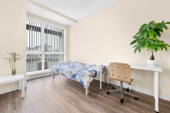 Bedroom with baseboards and wood finished floors | Image 14