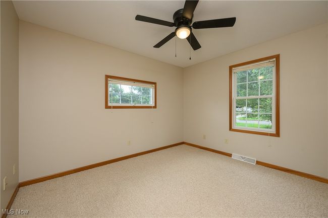 Unfurnished room with light colored carpet and a ceiling fan | Image 16