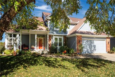 View of front of property featuring a front lawn and a garage | Image 1