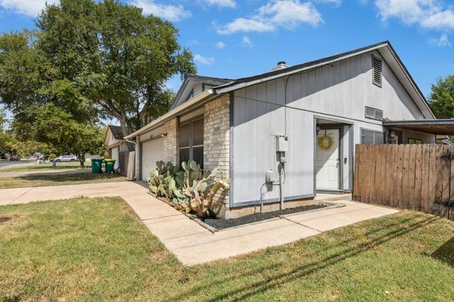 View of front of home with an attached garage, driveway, and a chimney | Image 4