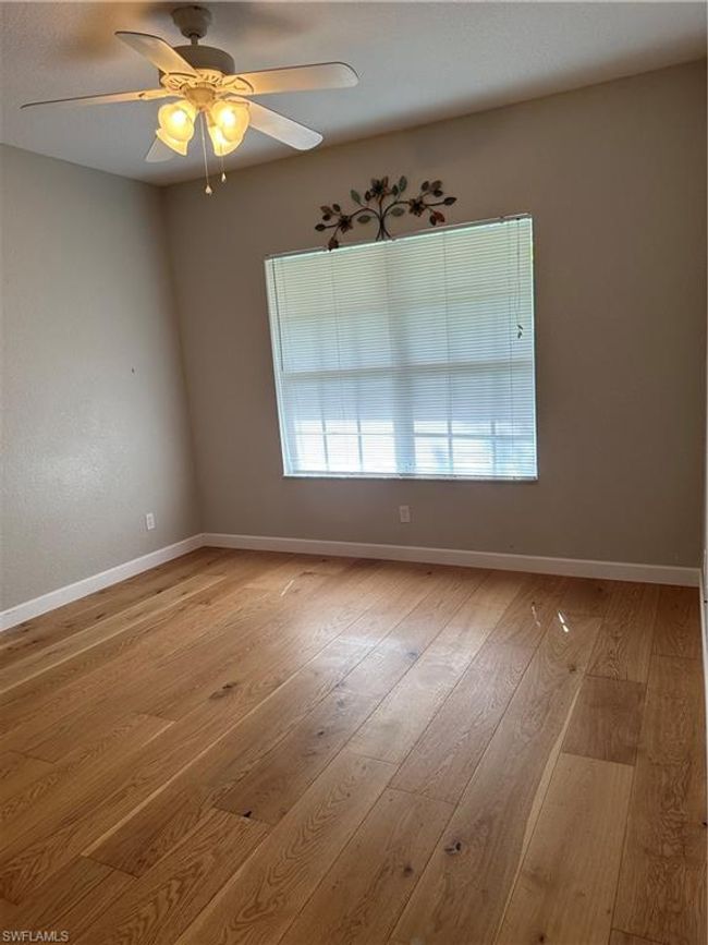 Empty room with ceiling fan and light hardwood / wood-style flooring | Image 11