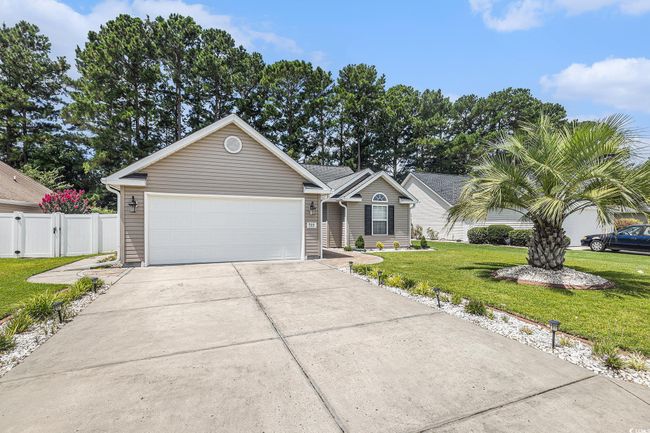 Ranch-style home with driveway and an attached garage | Image 37