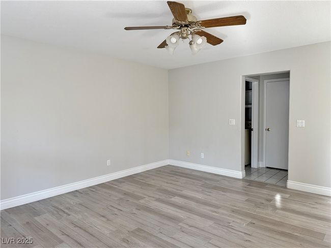 Unfurnished room featuring light wood finished floors, baseboards, and ceiling fan | Image 10