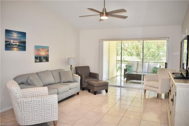Tiled living room with ceiling fan and vaulted ceiling | Image 6